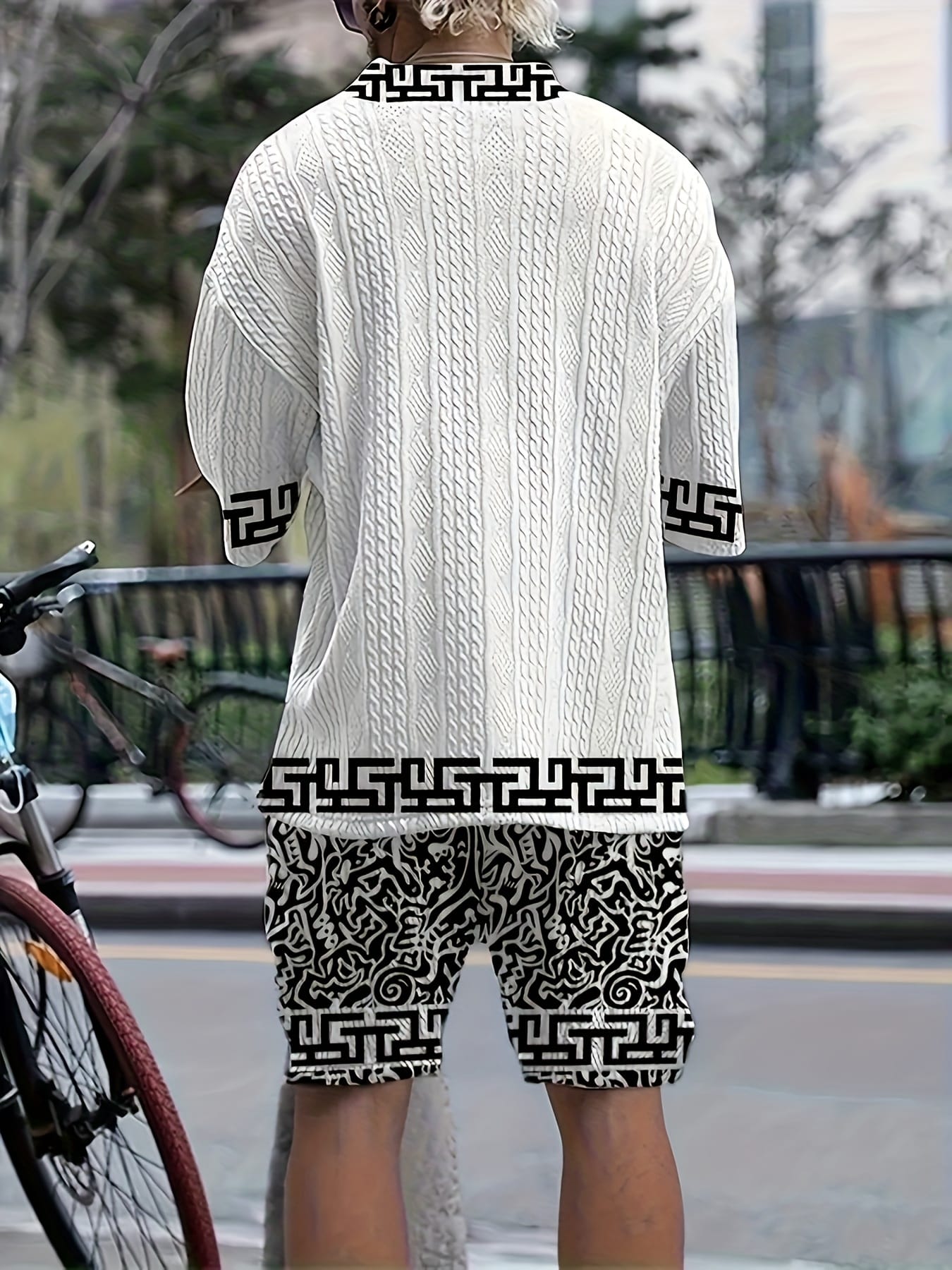Men's casual vacation style set, white diamond patterned V-neck mid sleeved top paired with black and white geometric printed shorts