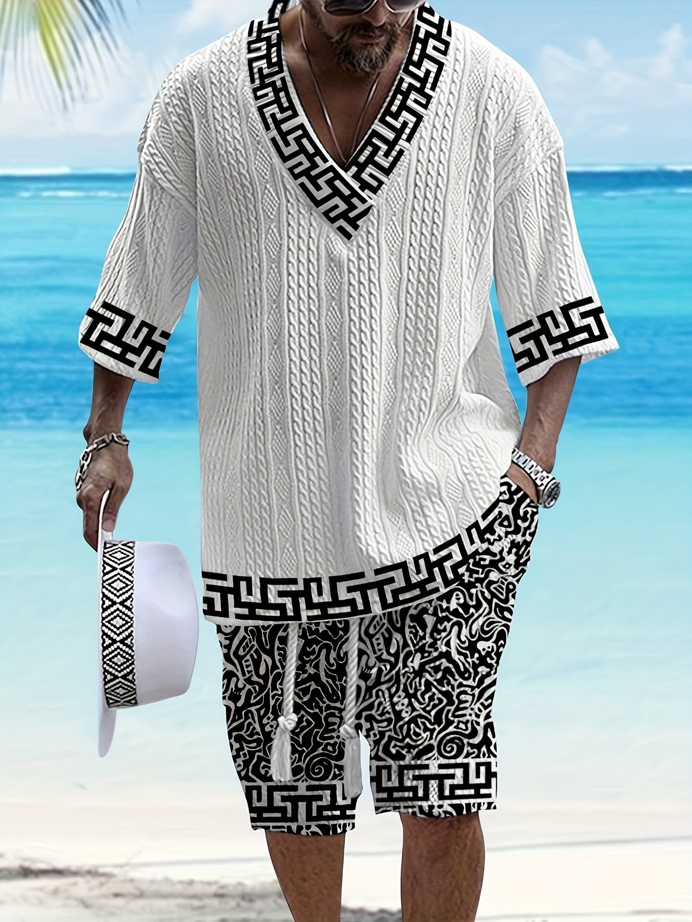 Men's casual vacation style set, white diamond patterned V-neck mid sleeved top paired with black and white geometric printed shorts