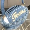 product-fancy-c4eb3c32-78c5-4dcb-bb1a-e0be4ac70d4a Denim Football-Shaped Handbag with Fringe and Adjustable Strap - Blue, Casual Style, Zip Closure, PU Lining - Perfect for Football Fans