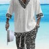 Men's casual vacation style set, white diamond patterned V-neck mid sleeved top paired with black and white geometric printed shorts